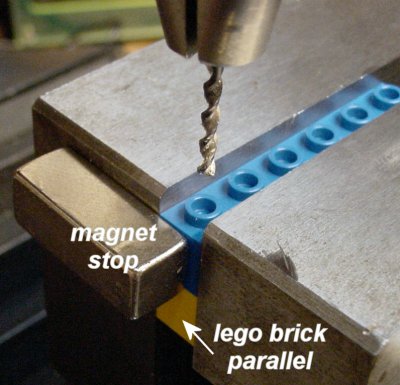 Repeatedly drilling into the center of a Lego nub by using a magnet on the side of a machining vise on a drill press.