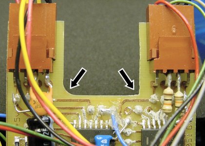 A square file shaved off the round edge (left) of the PCB, squaring it off (right). This provides more room in the tightly packed Hard2C mini sumo robot.