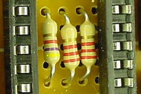 Three resistors form a voltage divider for sampling the batteries. They’re hiding inside the microcontroller socket!