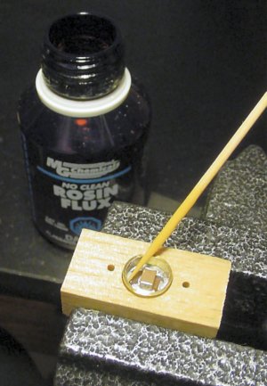 Pre-tin the surface to be soldered and then apply some soldering flux.