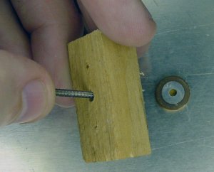 A hole in the back of the fixture allows a screw to quickly eject the workpiece for fast cooling on a metal plate.