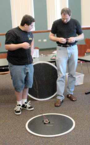 David and Brian testing the robot on a regulation mini-Sumo ring.