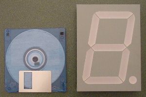 Massive numeric display beside a floppy disk (to show scale)