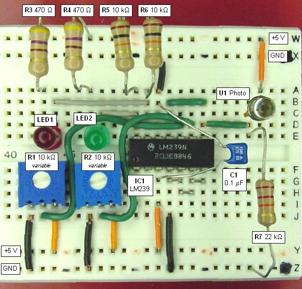 Solderless breadboard with sensor, comparator, and LEDs