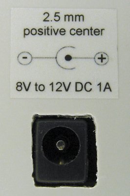 Oops! A not-quite square sticker and a poorly-cut power-plug hole.
