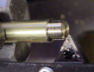 Chamfering the button to eliminate sharp edges.