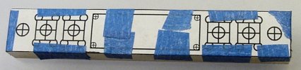 Taping a paper template to a metal workpiece with finished dimensions.