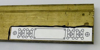 Tracing a CAD printout with a black marker on raw material.