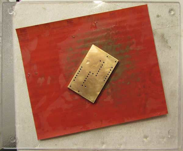 Sanding brass face on glass cutting board