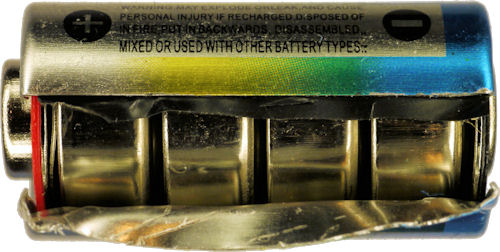 Alkaline 6V 4LR44 battery peeled open