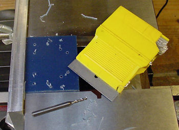 Screw holes drilled in blue UHMW plastic need razor blade scraping