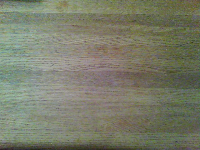 Hand print on wooden table visible