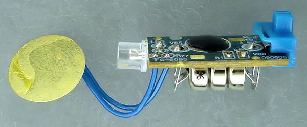 Avatar toy circuit board with blue LED, coin cells, and speaker.