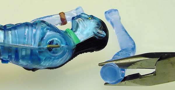 Detach toy arm with pliers.