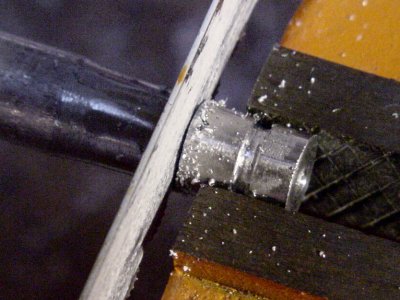 Cutting the replacement hub from the rod stock workpiece using a hacksaw with a bimetal blade.