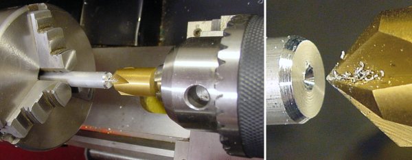 A large rigid drill starts a centered hole on a rod in a lathe.