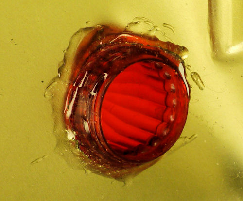 Epoxy secures taillight LED lens