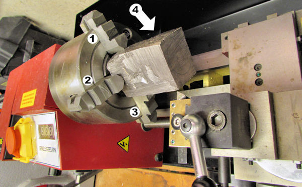 Getting ready to machine block on lathe with four jaw chuck
