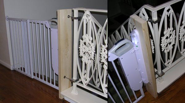 Child safety gate attached to a board at the edge of the baserail