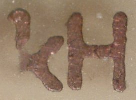 Text reading 'kH' at 60x magnification, showing bad transfer of 'k' and a crack in the middle of the 'H'