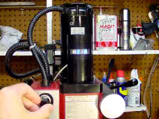 Click to see a movie of a homemade electronic tachometer display the speed of a hobbyist milling machine.