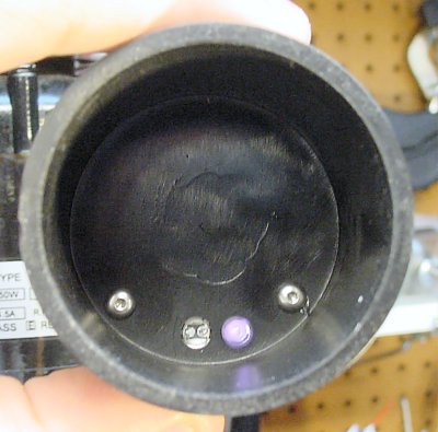 Inside the spindle cap, an infrared LED (looks purple in this photo) reflects light off the spindle and into the phototransistor.