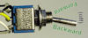 Toggling a switch to control motor direction.
