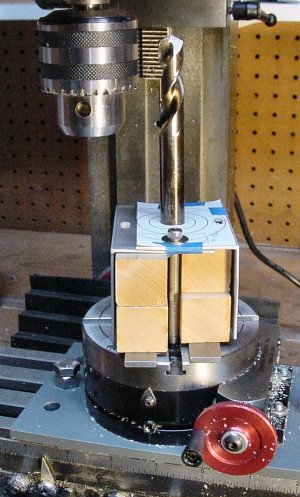 An unusually complex setup to hold two pieces of angle stock while machining a large hole using a rotary table.