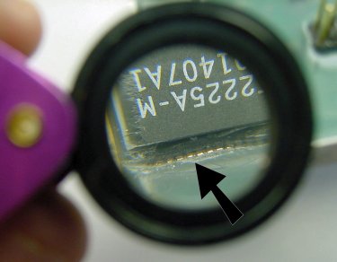 Chip pins exposed after scratching off the surrounding epoxy.