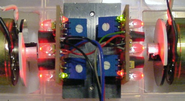 A closer look at a pair of back-to-back encoder boards with red LED emitters.
