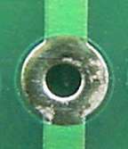 Hole with larger solder pad