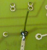 Bare bus wire connecting layers through a hole