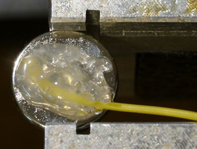 Hot glue on magnet for strain relief