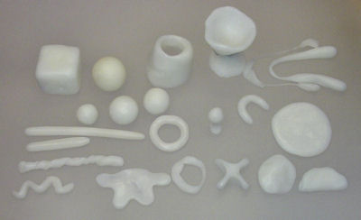Cubes, balls, rods, cups, and other shapes made with ShapeLock plastic.