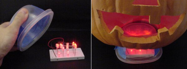Using a small plastic container to hold the LED light source under an artificial pumpkin.