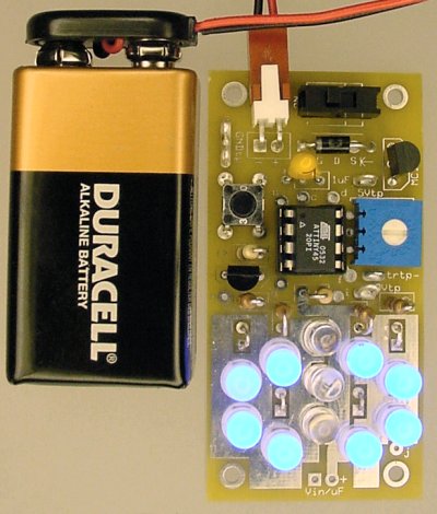 The completed LED pumpkin candle light with Atmel ATTiny45 microcontroller is slightly larger than a 9V battery.