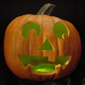 Pumpkin lit with green LEDs instead of a candle.