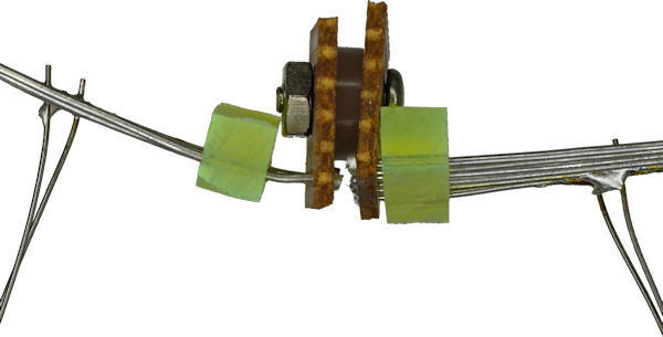 Bus loop physically connected by screw with non conductive spacer