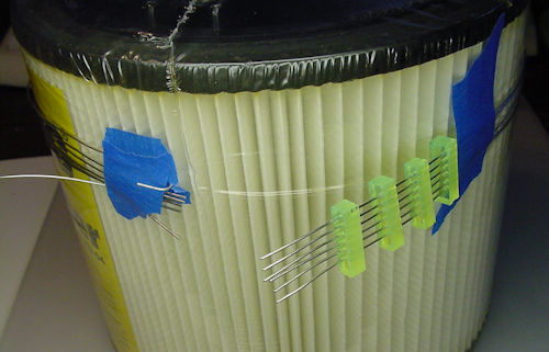 Wrapping around wet vac filter for shape