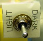 Light, off, dark line-following toggle switch