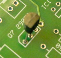 Transistor raised up off the board. Flat side of transistor faces forward, matching shape of silkscreen on board.