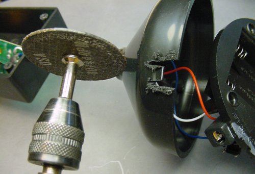 Roughing-out the AC plug slot with a Dremel rotary tool.